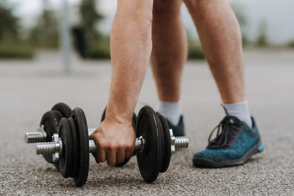 Man lifting dumbbell outdoor workout