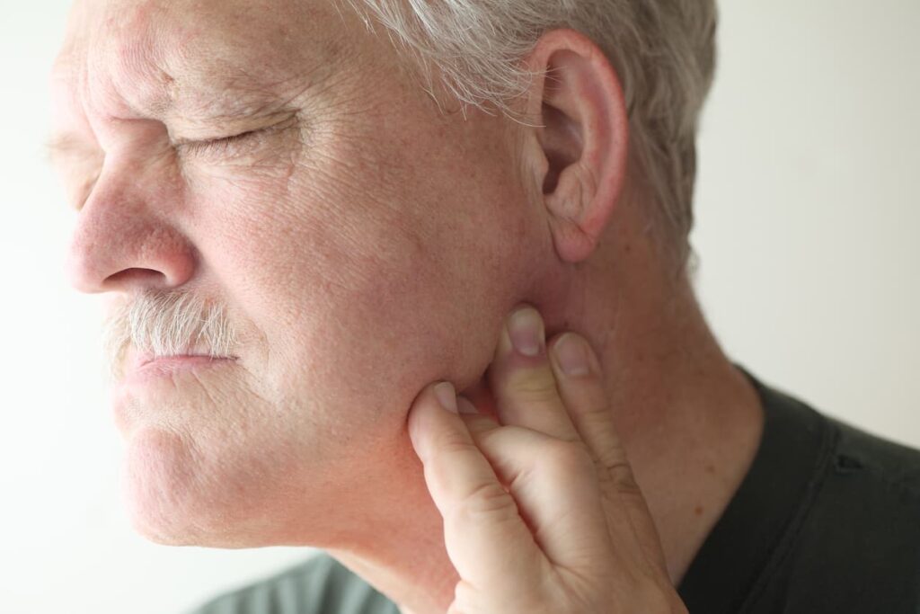 Man experiencing jaw pain treated with TMJ physiotherapy in Ottawa