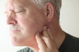 Man experiencing jaw pain treated with TMJ physiotherapy in Ottawa